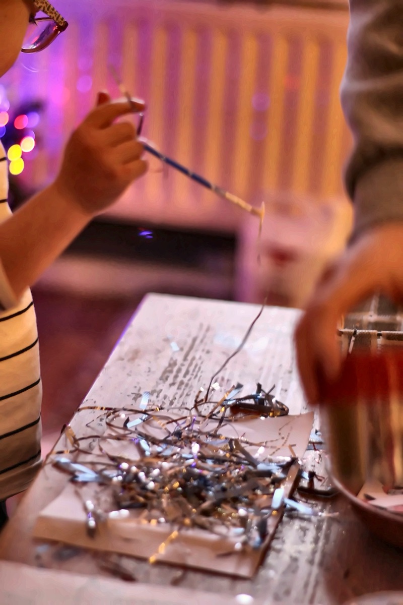 Children doing tinsel art and crafts at Mucky Pups